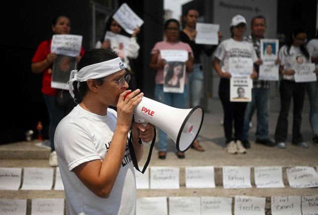 A man shouts slogans to demand freedom for political prisoners on the stairs of El Helicoide -a facility and prison owned by the Venezuelan government and used for both regular and political prisoners of the Bolivarian National Intelligence Service (SEBIN)- in Caracas on January 10, 2026. Venezuelan authorities are releasing a "large number" of prisoners, some of them foreigners, five days after US forces ousted president Nicolas Maduro. (Photo by Federico PARRA / AFP)