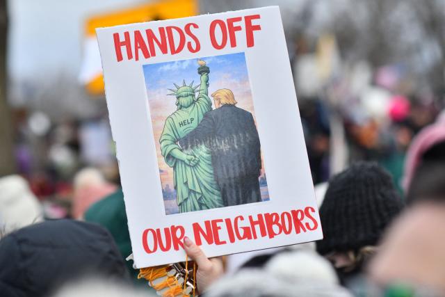 A protester holds up a sign as they march from Powderhorn Park in Minneapolis against Immigration and Customs Enforcement (ICE) and the fatal shooting of Renee Good by an ICE agent, calling on federal authorities to leave the city and demand accountability, in Minneapolis, Minnesota, on January 10, 2026. A US Immigration and Customs Enforcement (ICE) agent shot and killed 37-year-old Renee Nicole Good on the streets of Minneapolis on January 7, leading to huge protests and outrage from local leaders who rejected White House claims she was a domestic terrorist. (Photo by Octavio JONES / AFP)