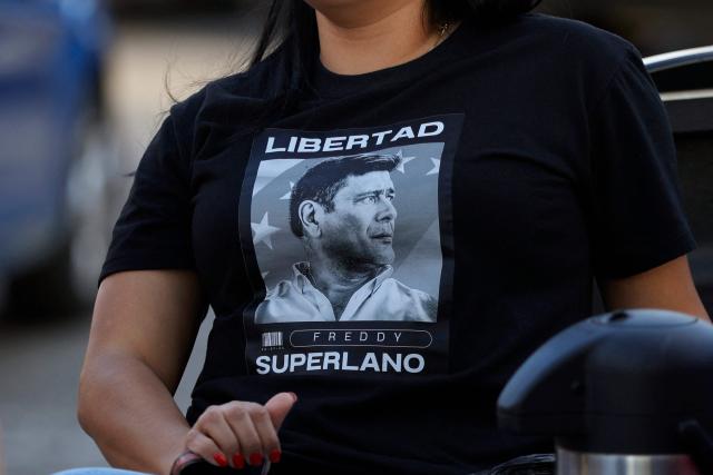 A woman wears a shirt demanding freedom for political prisoner Freddy Superlano outside El Rodeo I prison in Guatire, Miranda State, some 30 kilometers east of Caracas on January 10, 2026. Venezuela on January 8 began releasing a "large number" of political prisoners, including several foreigners, in a move praised by US President Donald Trump as a step toward cooperation after the ouster of ruler Nicolas Maduro. (Photo by Pedro MATTEY / AFP)