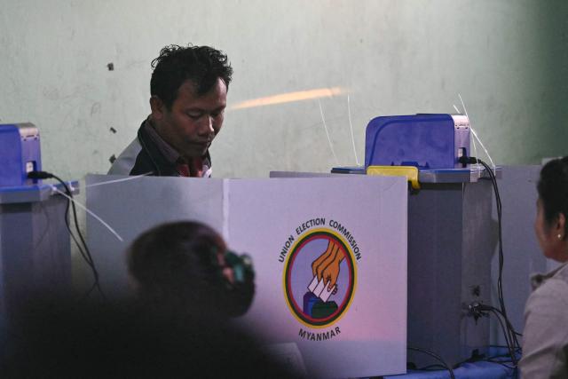 A man casts his vote at a polling station during the second phase of Myanmar's general election at Kawhmu township in Yangon on January 11, 2026. Myanmar's junta opened polls on January 11 in the second phase of elections, continuing a vote democracy watchdogs say is letting the military prolong its rule in a civilian guise. (Photo by Sai Aung MAIN / AFP)