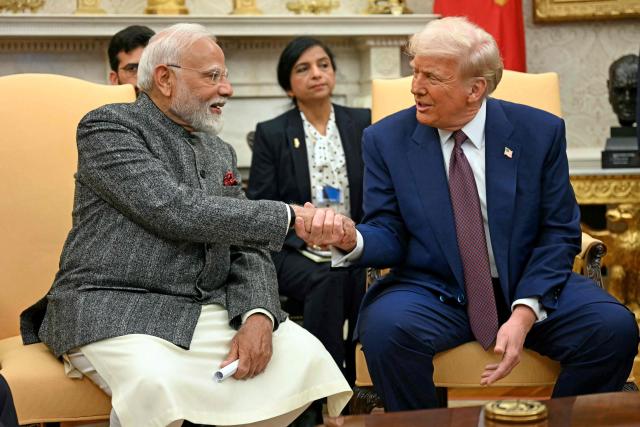 (FILES) US President Donald Trump (R) shakes hands with Indian Prime Minister Narendra Modi in the Oval Office of the White House in Washington, DC, on February 13, 2025. India is aggressively seeking trade deals to open markets for exporters and soften the blow of steep US tariffs, as efforts to secure an agreement with Washington remain elusive. (Photo by Jim WATSON / AFP)