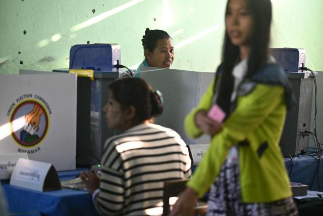 People cast their vote inside a polling station during the second phase of Myanmar's general election at Kawhmu township in Yangon on January 11, 2026. Myanmar's junta opened polls on January 11 in the second phase of elections, continuing a vote democracy watchdogs say is letting the military prolong its rule in a civilian guise. (Photo by Sai Aung MAIN / AFP)