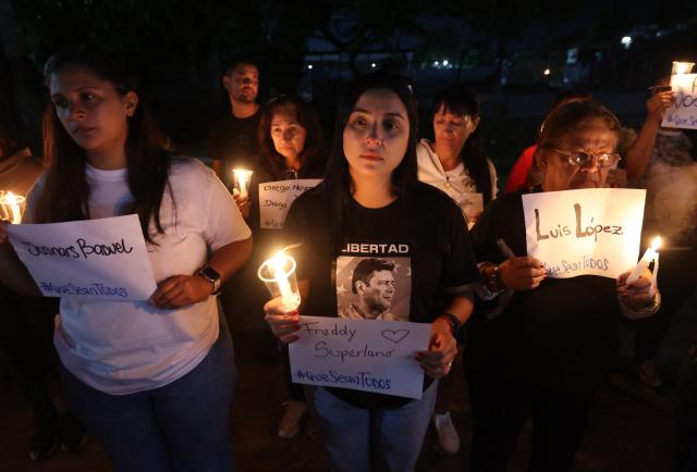 Relatives of political prisoners lit candles during a vigil outside El Rodeo I prison in Guatire, Miranda State, some 30 kilometers east of Caracas on January 10, 2026. Venezuela on January 8 began releasing a "large number" of political prisoners, including several foreigners, in a move praised by US President Donald Trump as a step toward cooperation after the ouster of ruler Nicolas Maduro. (Photo by Pedro MATTEY / AFP)