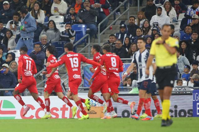 Toluca's Brazilian midfielder #11 Helinho celebrates with teammates after scoring the opening goal during the Liga MX Clausura football match between Monterrey and Toluca at BBVA Stadium in Monterrey, Nuevo Leon state, Mexico on January 10, 2026. (Photo by Julio Cesar AGUILAR / AFP)