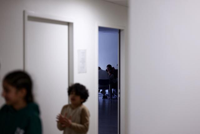 Families stay at an empty school near the Blandan's park in Lyon, south-eastern France, on January 10, 2026 where homeless families are being housed by a collective. Classrooms turned into dormitories and a cafeteria: more than 80 children without a roof over their heads are occupying an empty school in Lyon with their parents, in an operation of a "highly exceptional" scale carried out on January 9, 2026 evening by the collective "Jamais Sans Toit" (JST) due to the lack of housing solutions. (Photo by Alex MARTIN / AFP)