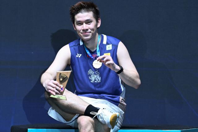 Gold medallist Thailand’s Kunlavut Vitidsarn poses with his trophy during the awards ceremony after the men’s single final match against China's Shi Yuqi at the Malaysia Open badminton tournament in Kuala Lumpur on January 11, 2026. (Photo by MOHD RASFAN / AFP)