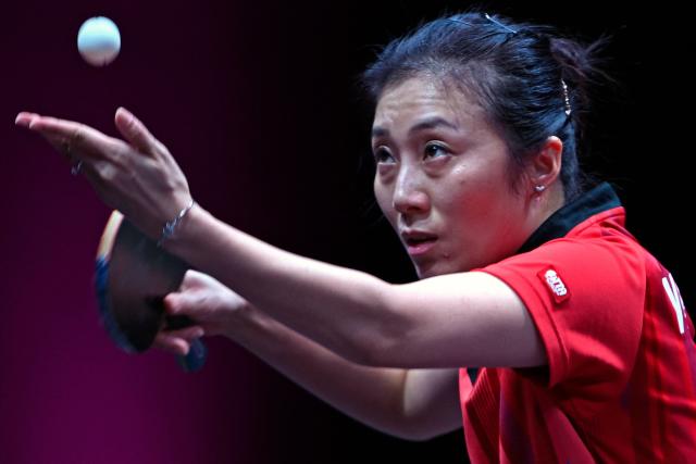 Germany's Han Ying serves against Macau’s Zhu Yuling in their women's singles semi-final match during the World Table Tennis (WTT) Champions tournament at the Infinity Arena in Doha on January 11, 2026. (Photo by MAHMUD HAMS / AFP)