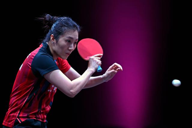 Germany's Han Ying hits a return against Macau’s Zhu Yuling in their women's singles semi-final match during the World Table Tennis (WTT) Champions tournament at the Infinity Arena in Doha on January 11, 2026. (Photo by MAHMUD HAMS / AFP)