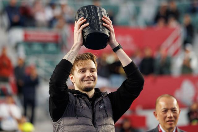 Kazakhstan's Alexander Bublik celebrates with the trophy after his victory against Italy's Lorenzo Musetti during the men's singles final at the Hong Kong Tennis Open in Hong Kong on January 11, 2026. (Photo by May JAMES / AFP)