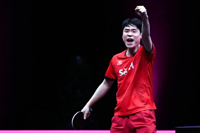 South Korea's Jang Woojin reacts during his match against China’s Lin Shidong during their men's singles semi-final match during the World Table Tennis (WTT) Champions tournament at the Infinity Arena in Doha on January 11, 2026. (Photo by MAHMUD HAMS / AFP)