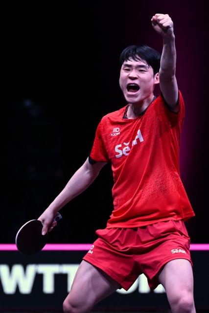 South Korea's Jang Woojin reacts during his match against China’s Lin Shidong during their men's singles semi-final match during the World Table Tennis (WTT) Champions tournament at the Infinity Arena in Doha on January 11, 2026. (Photo by MAHMUD HAMS / AFP)