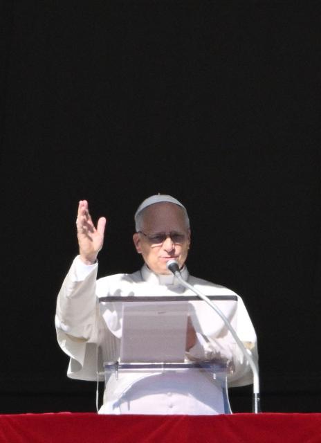 Pope Leo XIV addresses the crowd from the window of the apostolic palace overlooking St.Peter's square during his Sunday Angelus prayer at the Vatican on January 11, 2026. (Photo by Alberto PIZZOLI / AFP)