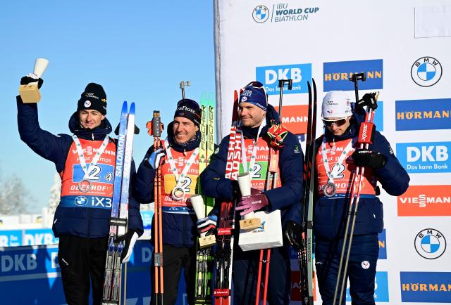 The second placed team of France with France's Eric Perrot, France's Quentin Fillon Maillet, France's Emilien Jacquelin and France's Fabien Claude pose on the podium after the men's 4x7,5km relay event of the IBU Biathlon World Cup in Oberhof, eastern Germany on January 11, 2026. (Photo by Tobias SCHWARZ / AFP)