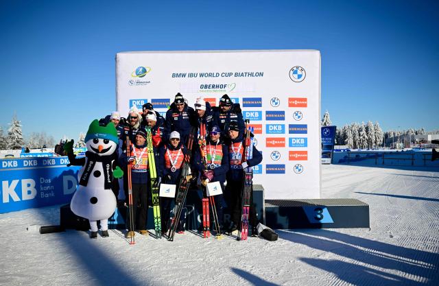The second placed team of France with France's Eric Perrot, France's Quentin Fillon Maillet, France's Emilien Jacquelin and France's Fabien Claude pose on the podium after the men's 4x7,5km relay event of the IBU Biathlon World Cup in Oberhof, eastern Germany on January 11, 2026. (Photo by Tobias SCHWARZ / AFP)