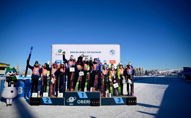 (L-R) The second placed team of France with France's Eric Perrot, France's Quentin Fillon Maillet, France's Emilien Jacquelin and France's Fabien Claude; the winning team of Norway with Norway's Vetle Sjastad Christiansen, Norway's Martin Uldal, Norway's Johannes Dale-Skjevdal and Norway's Isak Frey and the third placed team of Sweden with Sweden's Sebastian Samuelsson, Sweden's Martin Ponsiluoma, Sweden's Malte Stefansson and Sweden's Jesper Nelin pose on the podium after the men's 4x7,5km relay event of the IBU Biathlon World Cup in Oberhof, eastern Germany on January 11, 2026. (Photo by Tobias SCHWARZ / AFP)
