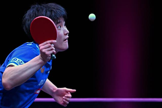 Japan's Tomokazu Harimoto serves against Taiwan's Lin Yun-ju during their men's singles semi-final match during the World Table Tennis (WTT) Champions tournament at the Infinity Arena in Doha on January 11, 2026. (Photo by MAHMUD HAMS / AFP)
