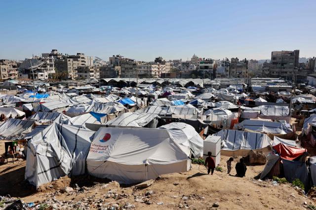 Tent shelters housing displaced Palestinian families are set-up on empty land in Gaza City on January 11, 2026. The majority of Gaza's 2.4 million people have been displaced, often multiple times, by the war that began with Hamas's attack on southern Israel on October 7, 2023. With displaced families living in tented camps, a serious concerns has been raised over their living conditions. (Photo by Omar AL-QATTAA / AFP)