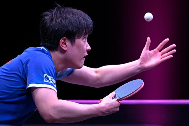 Japan's Tomokazu Harimoto serves against Taiwan's Lin Yun-ju during their men's singles semi-final match during the World Table Tennis (WTT) Champions tournament at the Infinity Arena in Doha on January 11, 2026. (Photo by Mahmud HAMS / AFP)