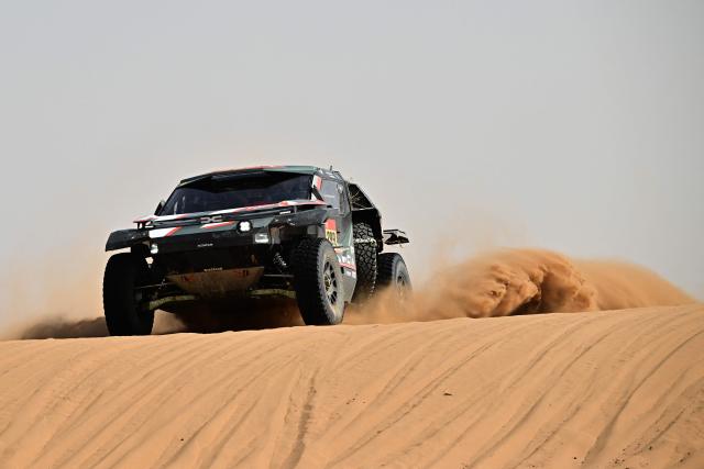 The Dacia Sandriders’s Qatari driver Nasser Al?Attiyah and Belgian co?pilot Fabian Lurquin compete in the Stage 7 of the 48th edition of the Dakar Rally 2026, between Riyadh and Wadi ad-Dawasir, Saudi Arabia, on January 11, 2026. (Photo by Giuseppe CACACE / AFP)