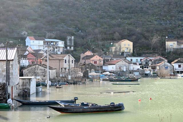 This photograph shows flooded houses in the fishermen's village of Vranjina, on the shores of Skadar lake, 25km South of Montenegro's capital of Podgorica, on January 11, 2026. Water level at Skadar lake has risen after heavy rain hit the area, causing a massive overflow on artificial lakes in neighboring Albania. (Photo by SAVO PRELEVIC / AFP)