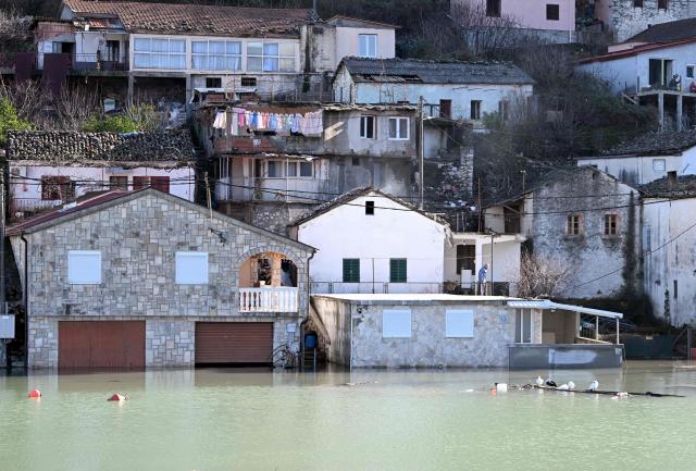 This photograph shows flooded houses in the fishermen's village of Vranjina, on the shores of Skadar lake, 25km South of Montenegro's capital of Podgorica, on January 11, 2026. Water level at Skadar lake has risen after heavy rain hit the area, causing a massive overflow on artificial lakes in neighboring Albania. (Photo by SAVO PRELEVIC / AFP)