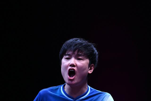 Japan's Tomokazu Harimoto reacts after a point against Taiwan's Lin Yun-ju during their men's singles semi-final match during the World Table Tennis (WTT) Champions tournament at the Infinity Arena in Doha on January 11, 2026. (Photo by Mahmud HAMS / AFP)