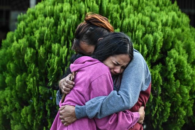 TOPSHOT - Relatives of inmates hug each other after visiting their loved ones for the first time, outside El Rodeo I prison in Guatire, Miranda State, some 30 kilometers east of Caracas on January 11, 2026. Venezuelans were waiting for more political prisoners to be released on Sunday, as ousted president Nicolas Maduro defiantly claimed from his US jail cell that he is "doing fine" after being seized by US forces a week ago. (Photo by Ronaldo SCHEMIDT / AFP)