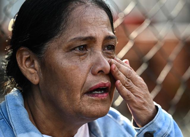A woman weeps after visiting her loved one for the first time, outside El Rodeo I prison in Guatire, Miranda State, some 30 kilometers east of Caracas on January 11, 2026. Venezuelans were waiting for more political prisoners to be released on Sunday, as ousted president Nicolas Maduro defiantly claimed from his US jail cell that he is "doing fine" after being seized by US forces a week ago. (Photo by Ronaldo SCHEMIDT / AFP)