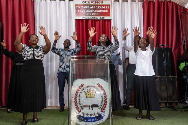 Christian worshippers praise and pray for a peaceful election at Wakaliga Pentecostal Church in Kampala, on January 11, 2026, ahead of the 2026 Ugandan general election. (Photo by Badru Katumba / AFP)