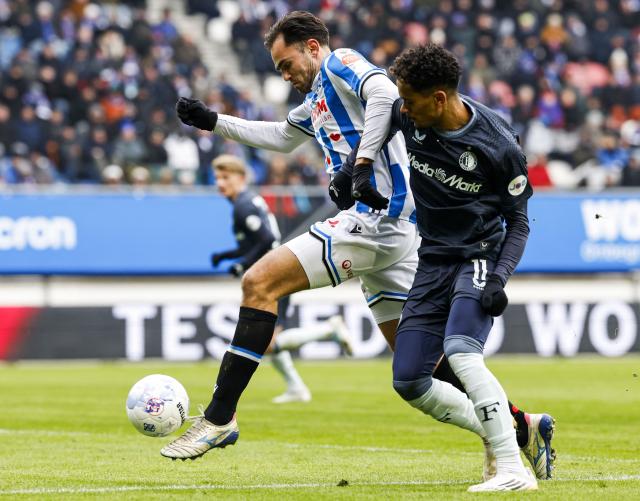 Heerenveen's Sam Kersten (L) fights for the ball with Feyenoord's Goncalo Borges during the Dutch Eredivisie match between SC Heerenveen and Feyenoord Rotterdam at the Abe Lenstra Stadium in Heerenveen on January 11, 2026. (Photo by MAURICE VAN STEEN / ANP / AFP) / Netherlands OUT