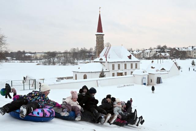 People ride snow tubes in Gatchina on January 11, 2026. (Photo by Olga MALTSEVA / AFP)