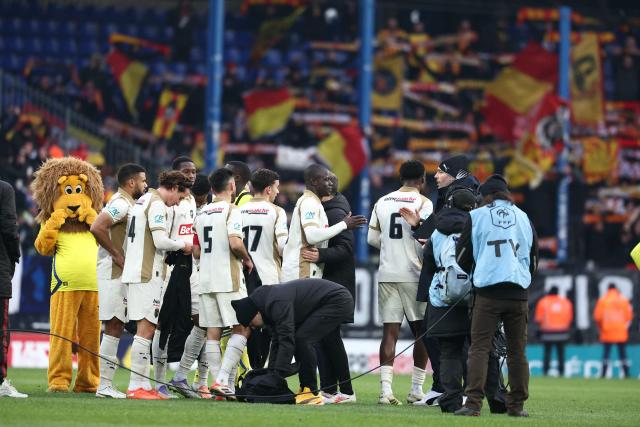 Lens’ players celebrate after winning the French Cup round of 32 football match between FC Sochaux-Montbeliard and RC Lens at the Auguste-Bonal stadium in Sochaux, eastern France on January 11, 2026. (Photo by Frederick FLORIN / AFP)