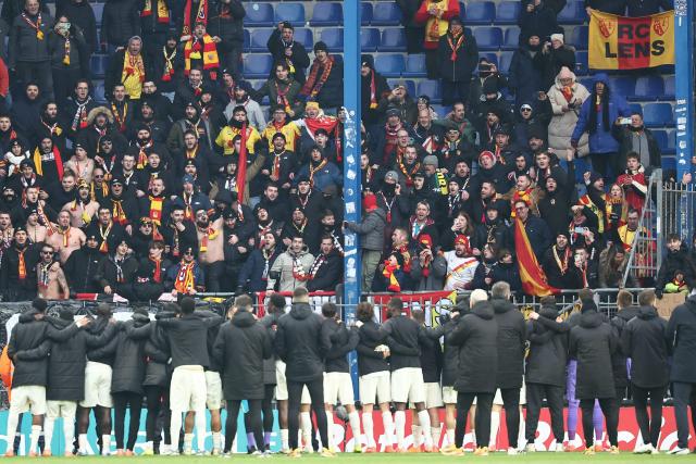 Lens’ players greet supporters after winning the French Cup round of 32 football match between FC Sochaux-Montbeliard and RC Lens at the Auguste-Bonal stadium in Sochaux, eastern France on January 11, 2026. (Photo by Frederick FLORIN / AFP)