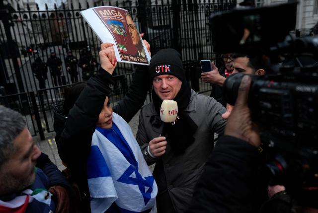 British far-right activist Tommy Robinson, whose real name is Stephen Yaxley-Lennon attends a rally in Solidarity with Iran's Uprising, organised by The national Council of Resistance of Iran, outside Downing Street in central London on January 11, 2026, to protest against the Iranian regime's crackdown on internet access and "recognise their right to self-defence against the regime's forces". At least 192 people have been killed in two weeks of protests against the government and economic strain in Iran, a rights group said on Sunday, in a sharp rise from an earlier death toll of 51. (Photo by CARLOS JASSO / AFP)