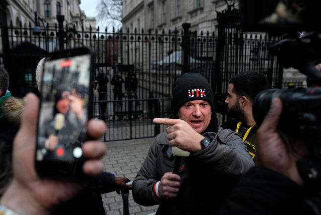 British far-right activist Tommy Robinson, whose real name is Stephen Yaxley-Lennon attends a rally in Solidarity with Iran's Uprising, organised by The national Council of Resistance of Iran, outside Downing Street in central London on January 11, 2026, to protest against the Iranian regime's crackdown on internet access and "recognise their right to self-defence against the regime's forces". At least 192 people have been killed in two weeks of protests against the government and economic strain in Iran, a rights group said on Sunday, in a sharp rise from an earlier death toll of 51. (Photo by CARLOS JASSO / AFP)