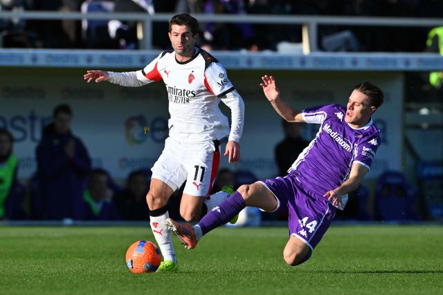 AC Milan's US forward #11 Christian Pulisic (L) fights for the ball with Fiorentina's Italian midfielder #44 Nicolo Fagioli during the Italian Serie A football match between ACF Fiorentina and AC Milan at Artemio Franchi stadium in Florence on January 11, 2026. (Photo by Andreas SOLARO / AFP)