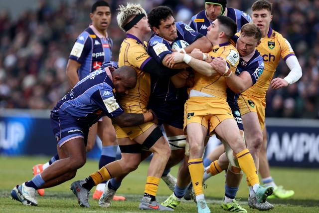 Bordeaux-Begles' French flanker Temo Matiu (C) is tackled by Northampton Saints' English number 8 Henry Pollock (L) and Northampton Saints' French fly-half Anthony Belleau (R) during the European Champions Cup first round, day 3, pool 4, rugby union match between Bordeaux-Begles and Northampton Saints at the Chaban-Delmas stadium in Bordeaux on January 11, 2026. (Photo by ROMAIN PERROCHEAU / AFP)