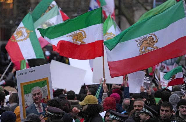 A protestor holds a placard of Iranian opposition figure and son of the last Shah of Iran, Reza Pahlav, during a rally in Solidarity with Iran's Uprising, organised by The national Council of Resistance of Iran, in central London on January 11, 2026, to protest against the Iranian regime's crackdown on internet access and "recognise their right to self-defence against the regime's forces". At least 192 people have been killed in two weeks of protests against the government and economic strain in Iran, a rights group said on Sunday, in a sharp rise from an earlier death toll of 51. (Photo by CARLOS JASSO / AFP)