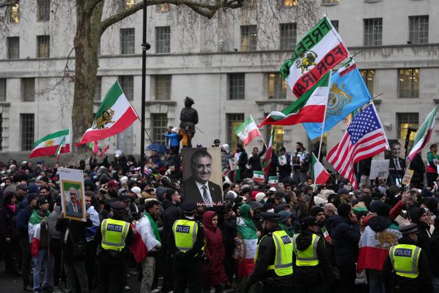 A protestor holds a placard of Iranian opposition figure and son of the last Shah of Iran, Reza Pahlav, during a rally in Solidarity with Iran's Uprising, organised by The national Council of Resistance of Iran, in central London on January 11, 2026, to protest against the Iranian regime's crackdown on internet access and "recognise their right to self-defence against the regime's forces". At least 192 people have been killed in two weeks of protests against the government and economic strain in Iran, a rights group said on Sunday, in a sharp rise from an earlier death toll of 51. (Photo by CARLOS JASSO / AFP)