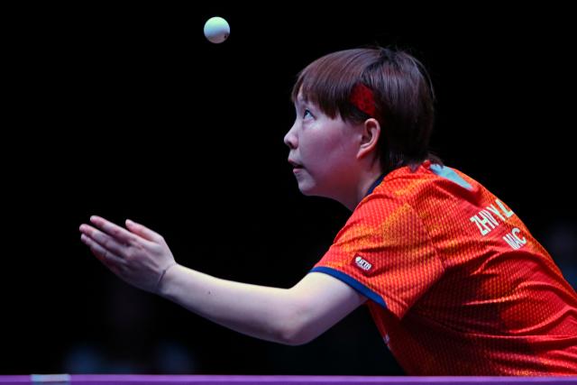 Macau’s Zhu Yuling serves against China's Chen Xingtong in their women's singles final match during the World Table Tennis (WTT) Champions tournament at the Infinity Arena in Doha on January 11, 2026. (Photo by MAHMUD HAMS / AFP)
