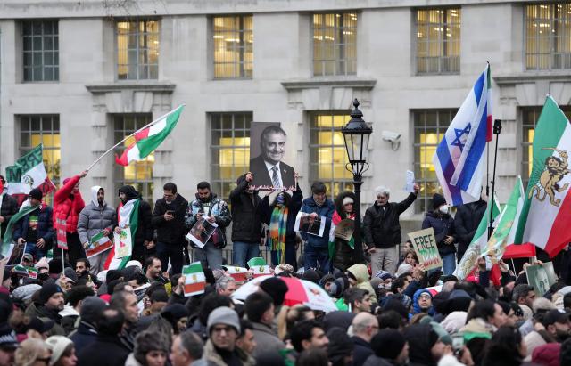 A protestor holds a placard of Iranian opposition figure and son of the last Shah of Iran, Reza Pahlav, during a rally in Solidarity with Iran's Uprising, organised by The national Council of Resistance of Iran, in central London on January 11, 2026, to protest against the Iranian regime's crackdown on internet access and "recognise their right to self-defence against the regime's forces". At least 192 people have been killed in two weeks of protests against the government and economic strain in Iran, a rights group said on Sunday, in a sharp rise from an earlier death toll of 51. (Photo by CARLOS JASSO / AFP)