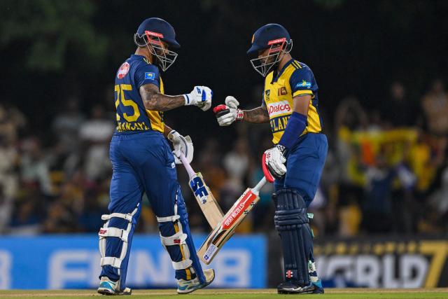 Sri Lanka's Dhananjaya de Silva (L) and Kusal Mendis bump their fists during the third and final Twenty20 international cricket match between Pakistan and Sri Lanka at the Rangiri Dambulla International Stadium in Dambulla on January 11, 2026. (Photo by Ishara S. KODIKARA / AFP)