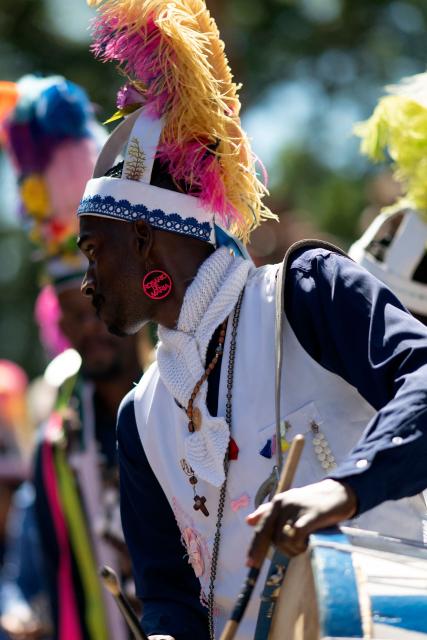 A reveller takes part in the traditional Reinado de Nossa Senhora do Rosario, Santa Efigenia e Sao Benedito (Reign of Our Lady of the Rosary, St Efigenia and St. Benedict) festival to honour Chico Rei, through the historic streets of Ouro Preto, Brazil, on January 11, 2026. According to tradition, Chico was the king of a tribe in Congo brought by the Portuguese as a slave and who managed to buy his freedom and that of other slaves to become 'king' in Ouro Preto and, from then on, part of the Brazilian folklore. More than 30 congado guards from Ouro Preto and the region take part in the event. (Photo by Douglas MAGNO / AFP)