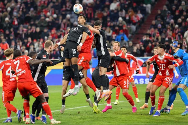 Wolfsburg's German defender #15 Moritz Jenz jumps to head the ball during the German first division Bundesliga football match between FC Bayern Munich and VfL Wolfsburg in Munich, southern Germany, on January 11, 2026. (Photo by Alexandra BEIER / AFP) / DFL REGULATIONS PROHIBIT ANY USE OF PHOTOGRAPHS AS IMAGE SEQUENCES AND/OR QUASI-VIDEO