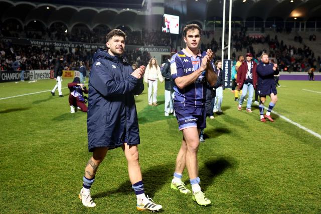 Bordeaux-Begles' French fly-half Matthieu Jalibert (L) and Bordeaux-Begles' French wing Damian Penaud (R) celebrate with supporters after winning the European Champions Cup first round, day 3, pool 4, rugby union match between Bordeaux-Begles and Northampton Saints at the Chaban-Delmas stadium in Bordeaux on January 11, 2026. (Photo by ROMAIN PERROCHEAU / AFP)