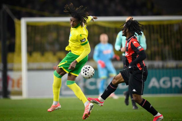 Nantes' French defender #04 Tylel Tati (L) fights for the ball with Nice's Nigerian forward #09 Terem Moffi during the French Cup round of 32 football match between FC Nantes and OGC Nice at the Stade de la Beaujoire–Louis Fonteneau in Nantes, western France on January 11, 2026. (Photo by Loic VENANCE / AFP)