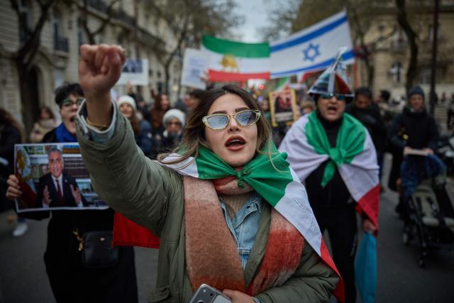 Protestors shout slogans during a demonstration to support mass rallies denouncing the Islamic republic in Iran in Paris on January 11, 2026. At least 192 protesters have been killed in Iran's biggest movement against the Islamic republic in more than three years, as warnings grew that authorities were committing a "massacre" to quell the demonstrations. The protests, initially sparked by anger over the rising cost of living, have now become a movement against the theocratic system in place in Iran since the 1979 revolution and have already lasted two weeks. (Photo by Kiran RIDLEY / AFP)