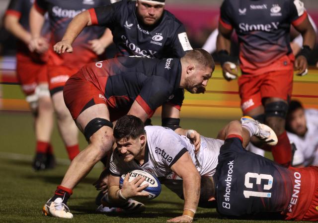 Saracens' English number 8 Tom Willis (L) and Saracens' English centre Alex Lozowski (R) stop Toulouse's French hooker Julien Marchand from scoring a try during the European Rugby Champions Cup pool 1, rugby union match between Saracens and Stade Toulousain at the StoneX Stadium in north London on January 11, 2026. (Photo by Adrian Dennis / AFP)
