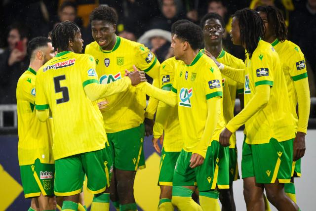 Nantes' French forward #11 Herba Guirassy celebrates with teammates after scoring his team's first goal during the French Cup round of 32 football match between FC Nantes and OGC Nice at the Stade de la Beaujoire–Louis Fonteneau in Nantes, western France on January 11, 2026. (Photo by Loic VENANCE / AFP)