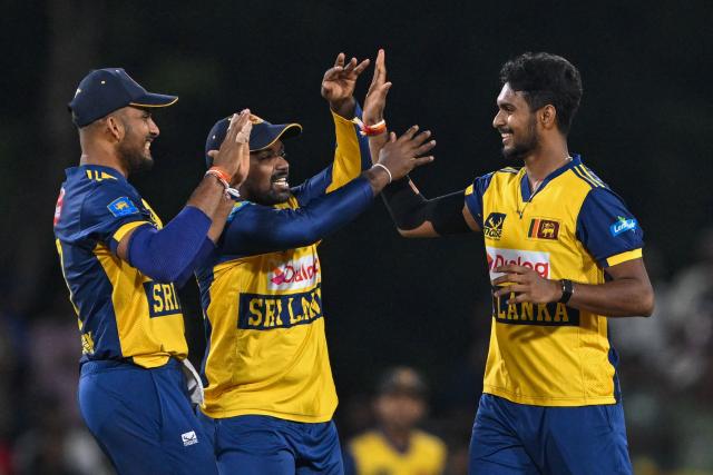 Sri Lanka's Matheesha Pathirana (R) celebrates with teammates after taking the wicket of Pakistan's captain Salman Agha during the third and final Twenty20 international cricket match between Pakistan and Sri Lanka at the Rangiri Dambulla International Stadium in Dambulla on January 11, 2026. (Photo by Ishara S. KODIKARA / AFP)
